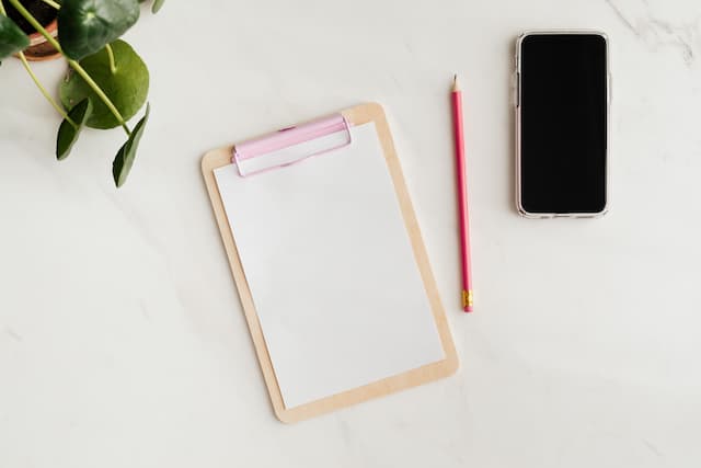 table, a mobile phone and a pencil, copy space